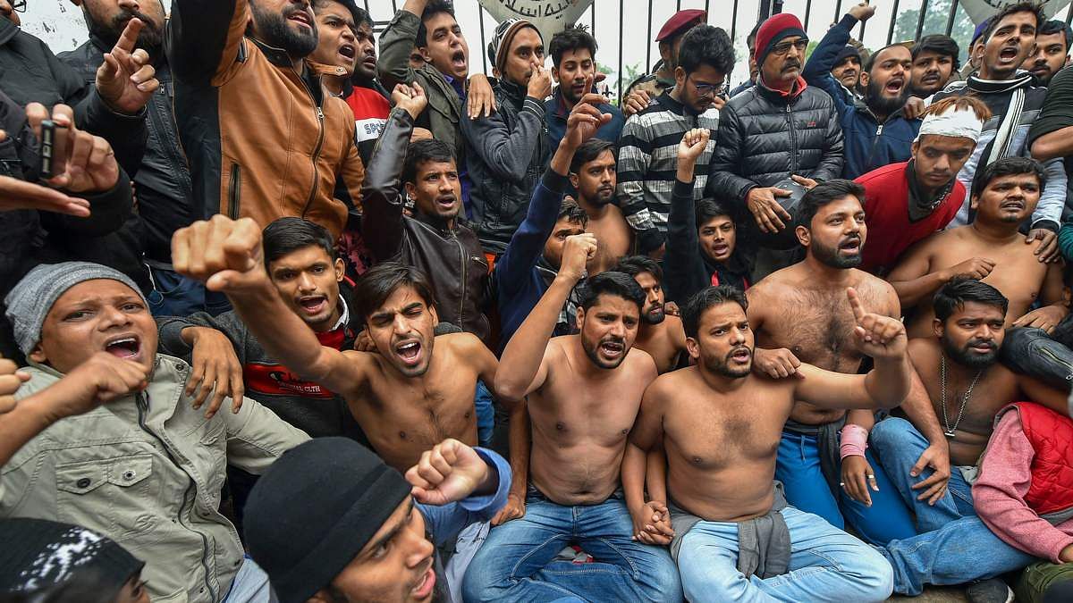 Students protest shirtless at the campus against Delhi Police's action on students at Jamia Millia Islamia