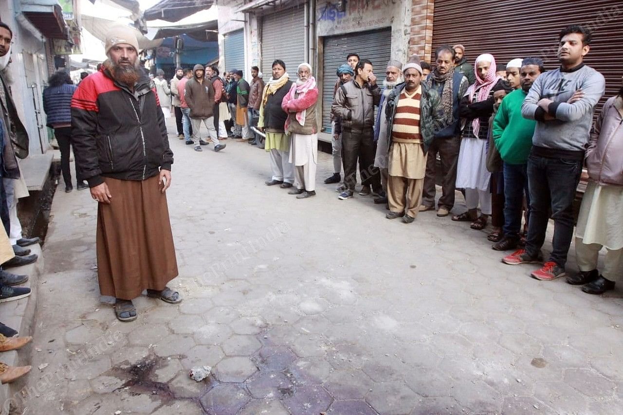 Arshad Hussian father of Mohemed Anas standing on the street in front of the blood spot | Photo: Praveen Jain | ThePrint