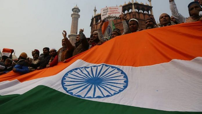 Protestors with the Indian tricolour at Jama Masjid | Photo: Manisha Mondal | ThePrint