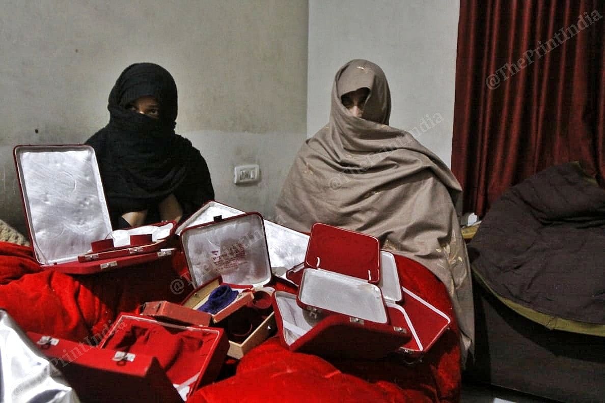 women sitting with jewellery box