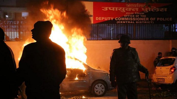 A car was set on fire outside Dariyaganj police station during anti-CAA protests in New Delhi | Photo: Manisha Mondal | ThePrint