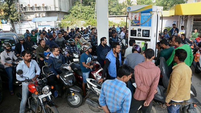 People queue up at a petrol pump after curfew was relaxed from 9am to 4pm in Guwahati | PTI