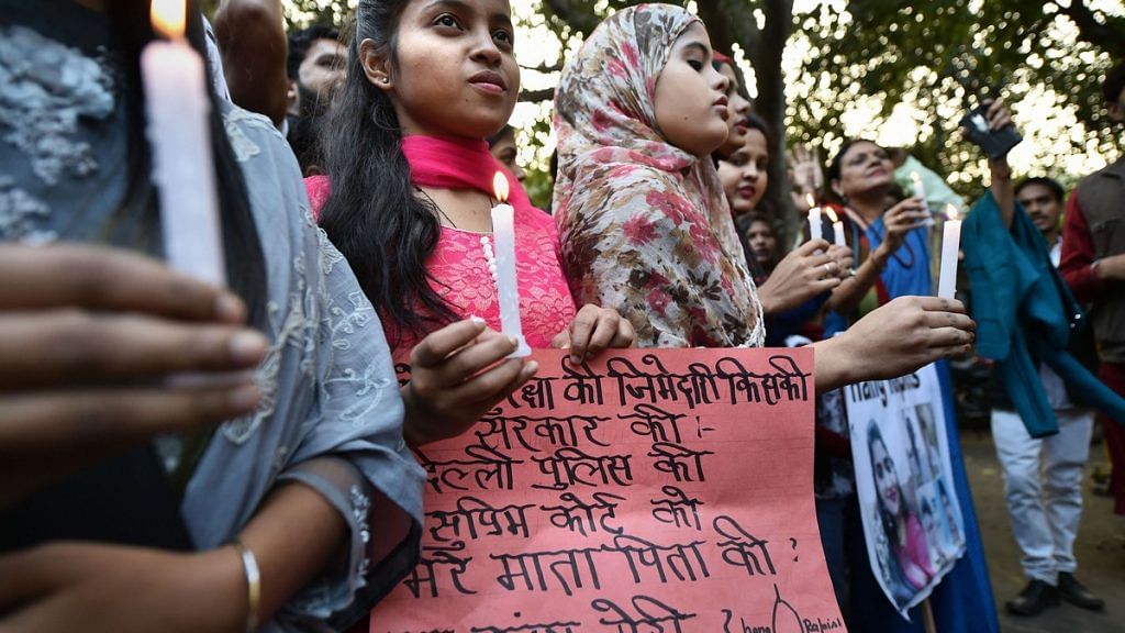 Girls, along with activists, take part in a candle-light protest over the Hyderabad rape-murder case, in New Delhi | PTI