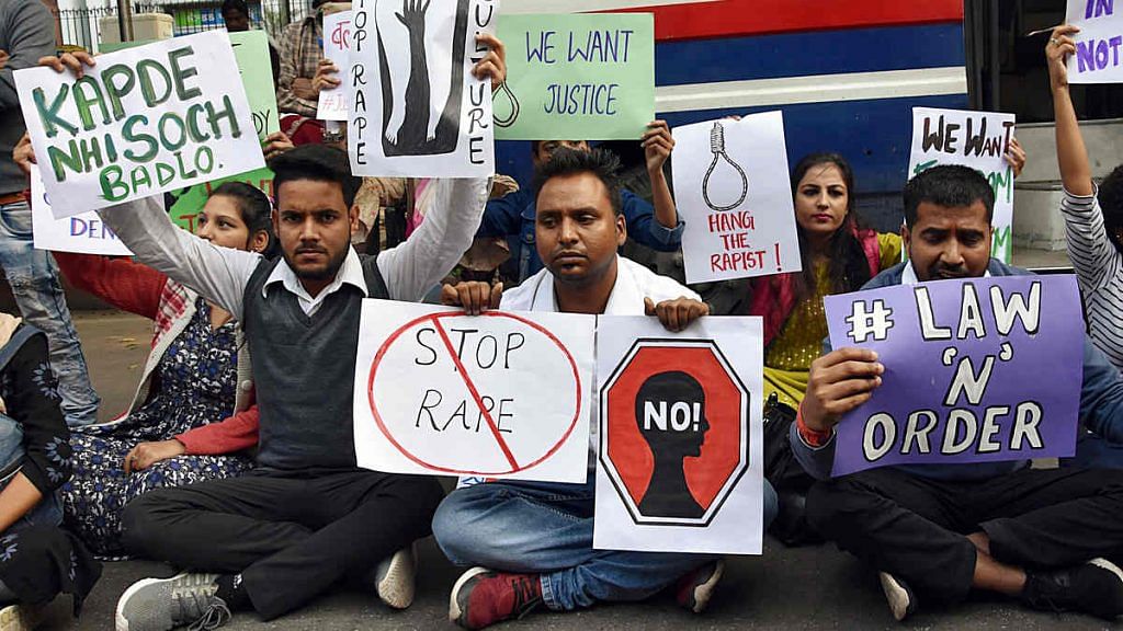 People hold placards during a protest in New Delhi against the alleged rape and murder of a veterinary doctor in Hyderabad.
