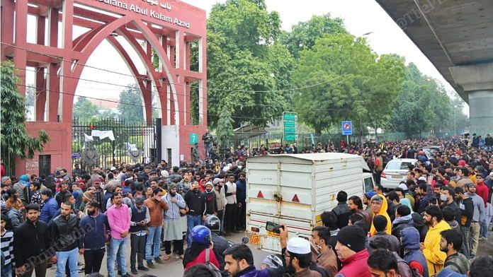 Protestors gather on the main road at Jamia Millia Islamia to pretest against the brutal police action on Sunday