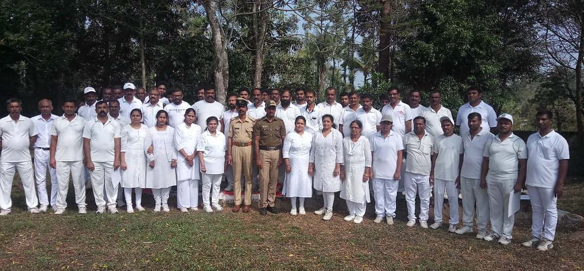 Police personnel with women at a rifle training camp in Kodagu's Gonikoppal village. | Photo: By special arrangement 