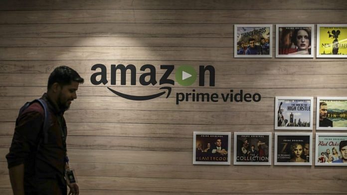 An employee walks past a Amazon Prime Video art wall at the Amazon Inc. campus in Hyderabad | Dhiraj Singh/Bloomberg