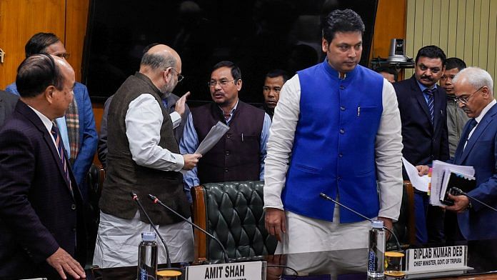 Union Home Minister Amit Shah (C) interacts with Bru community people as Tripura Chief Minister Biplab Kumar Deb (blue jacket) and Mizoram CM Zoramthanga (L) look on, during signing of an agreement for permanent settlement of displaced Bru tribals in Tripura, in New Delhi, Thursday. | Photo: PTI