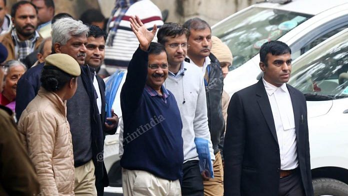 Arvind Kejriwal waves as he arrives at Jamnagar House to file his nomination papers in New Delhi on 21 January