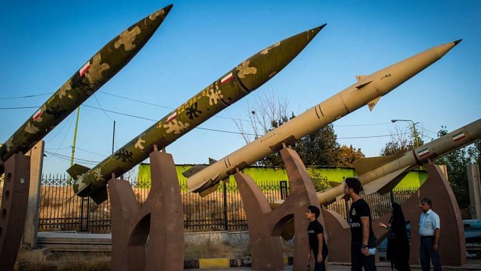 Visitors look at a missile display at a military museum in Tehran, Iran | Ali Mohammadi | Bloomberg File Photo