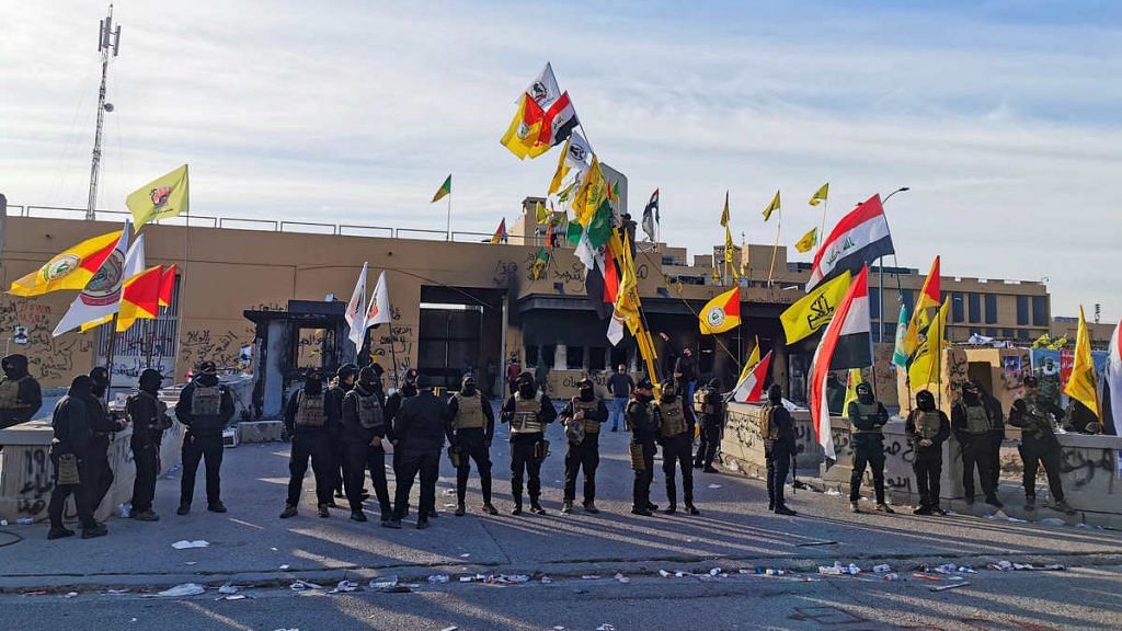 File photo of Iraqi security forces standing guard as protesters and militia fighters gather outside the U.S. Embassy in Baghdad on 1 January