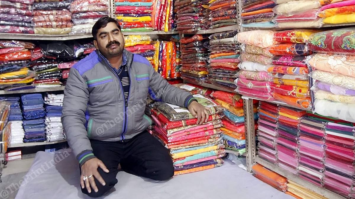 Mewa Lal Yadav at his fabric shop in Tharwai, Prayagraj | Photo: Praveen Jain | ThePrint