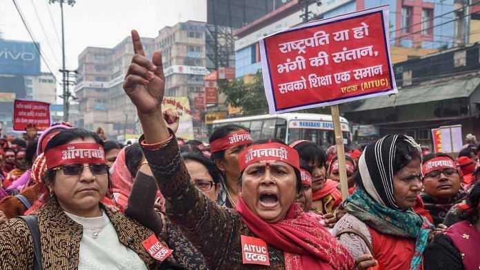 Anganbadi workers raise slogans during a nationwide strike called by trade unions, in Patna