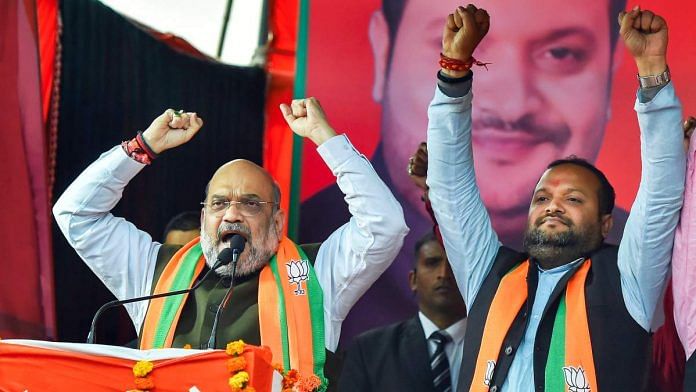 Home Minister Amit Shah with party candidate Manish Choudhary during an election campaign ahead of the forthcoming Delhi Assembly elections, at Rithala constituency in New Delhi | PTI