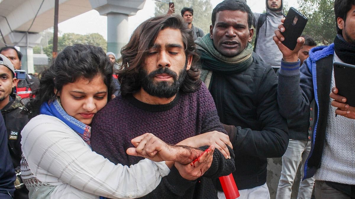 Astudent (C) of the Jamia Millia Islamia university, injured after an unidentified person allegedly opened firing during an anti-CAA protest | PTI