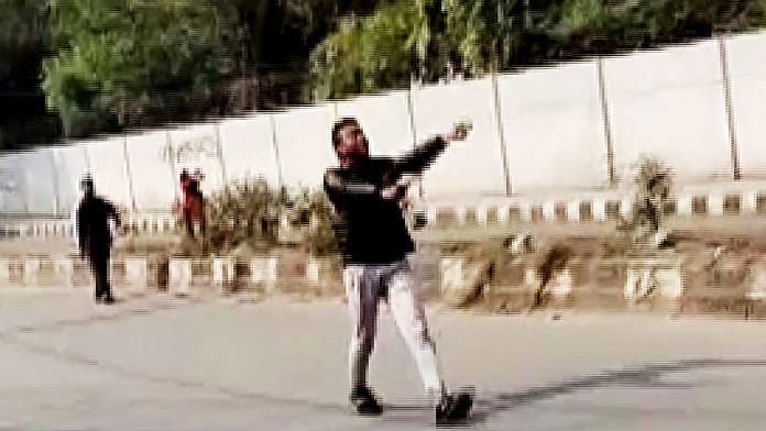 A man brandishes a gun at Jamia area, in New Delhi on Thursday | ANI