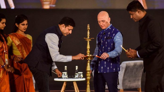 Amazon chief Jeff Bezos lights the ceremonial lamp with Amazon Global Senior Vice President Amit Agarwal during Amazon SMBhav summit, at Jawahar Lal Nehru Stadium in New Delhi. | PTI