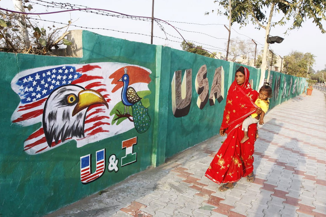 A woman passes by the the wall that is being constructed in Ahmedabad before Trump's visit to India | Photo: Praveen Jain | ThePrint 