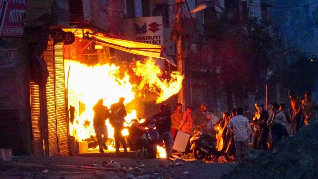 New Delhi: Rioters set ablaze a shop during clashes between those against and those supporting the Citizenship (Amendment) Act in at Gokalpuri in north east Delhi, Tuesday, Feb. 25, 2020 | PTI