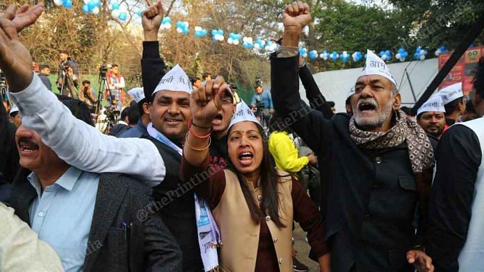 AAP supporters celebrate outside the party office in Delhi