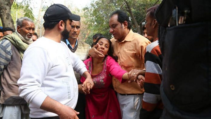 A Delhi riot victim's family grieves at GTB Hospital Wednesday | Photo: Suraj Singh Bisht | ThePrint