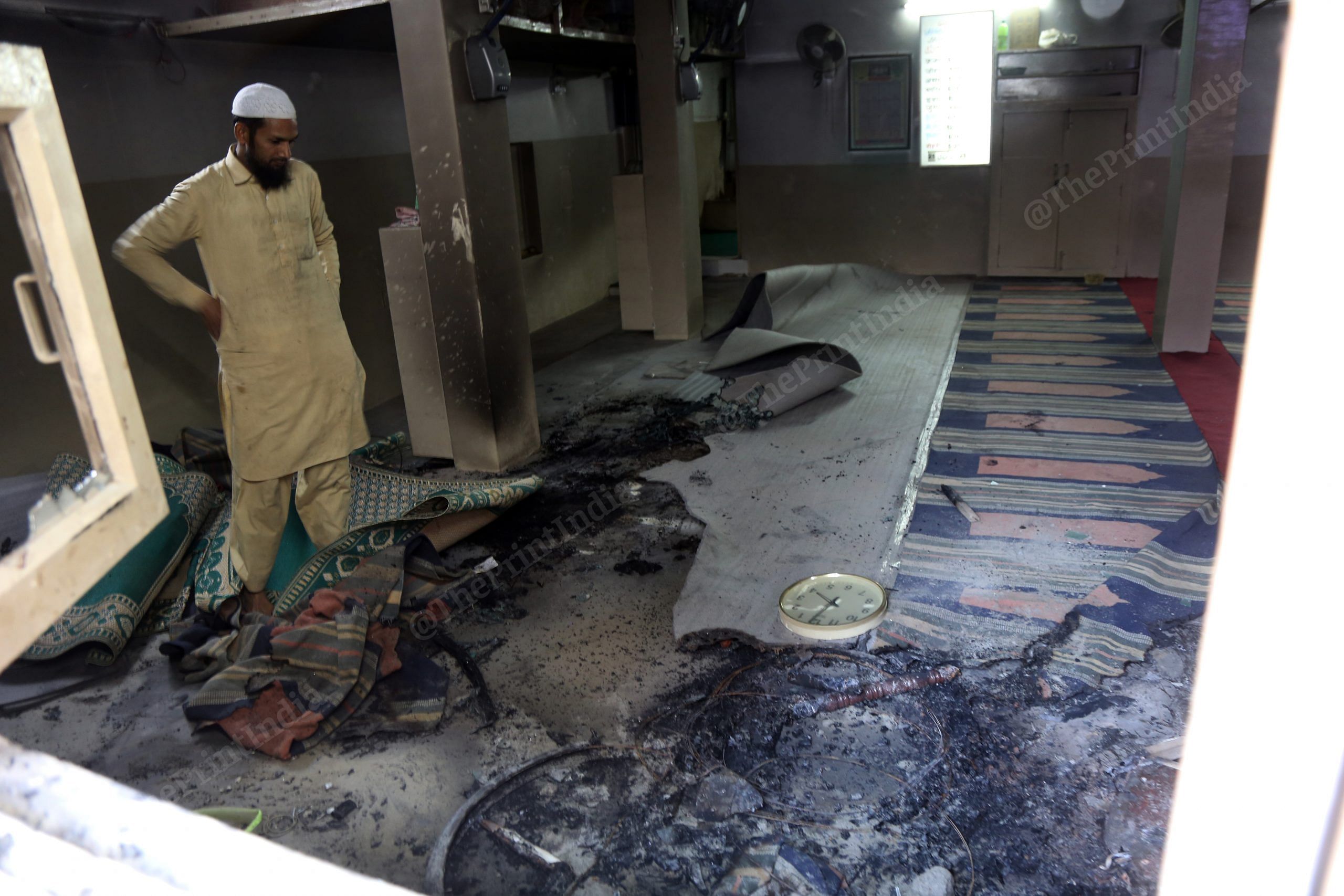 The caretaker of the Meena masjid evaluates the damage sustained in an arson attack on the mosque | Manisha Mondal | ThePrint