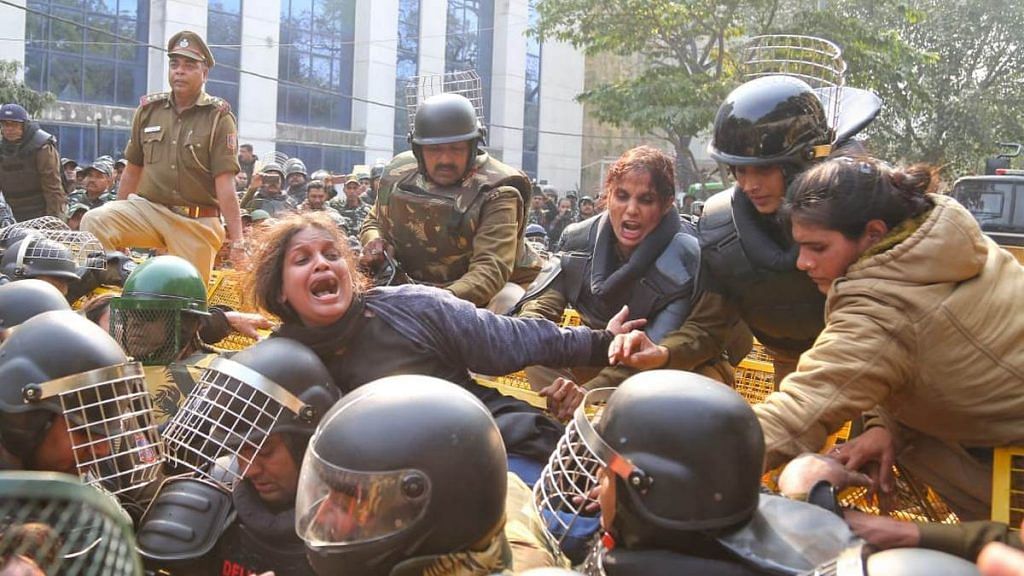 Students of Jamia Milia Islamia clash with police during an anti-CAA protest Monday