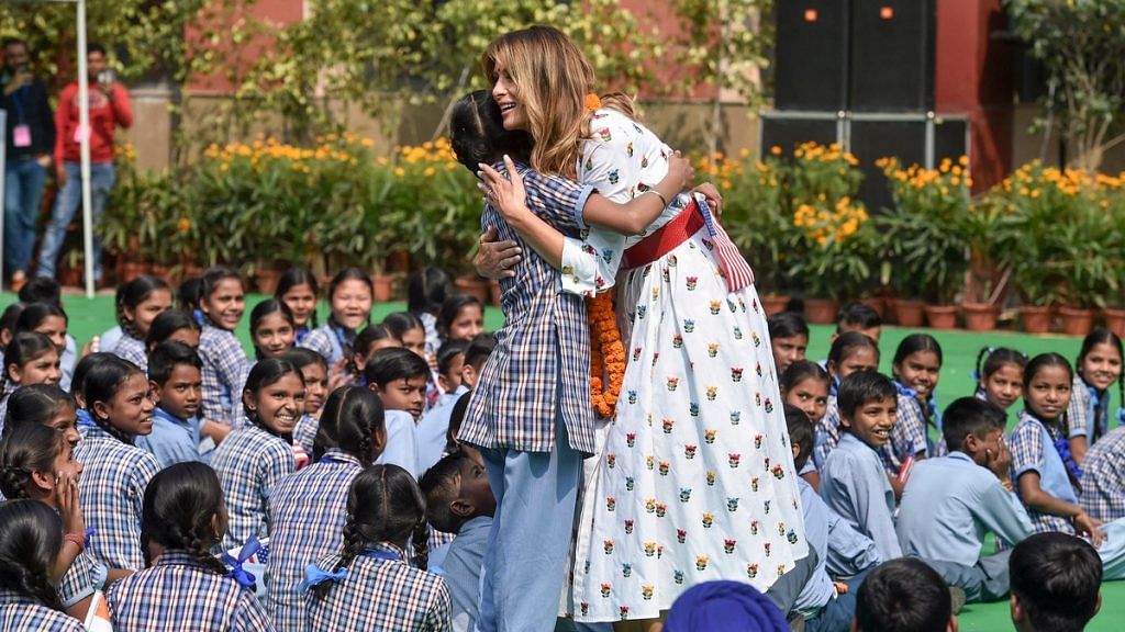US First Lady Melania Trump hugs a school girl as she attends 'Happiness Class', during her visit to a government school in New Delhi