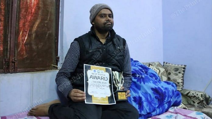 Jamia Millia Islamia law student Mohammed Minhajuddin with the best paper award he won Tuesday | Photo: Manisha Mondal | ThePrint