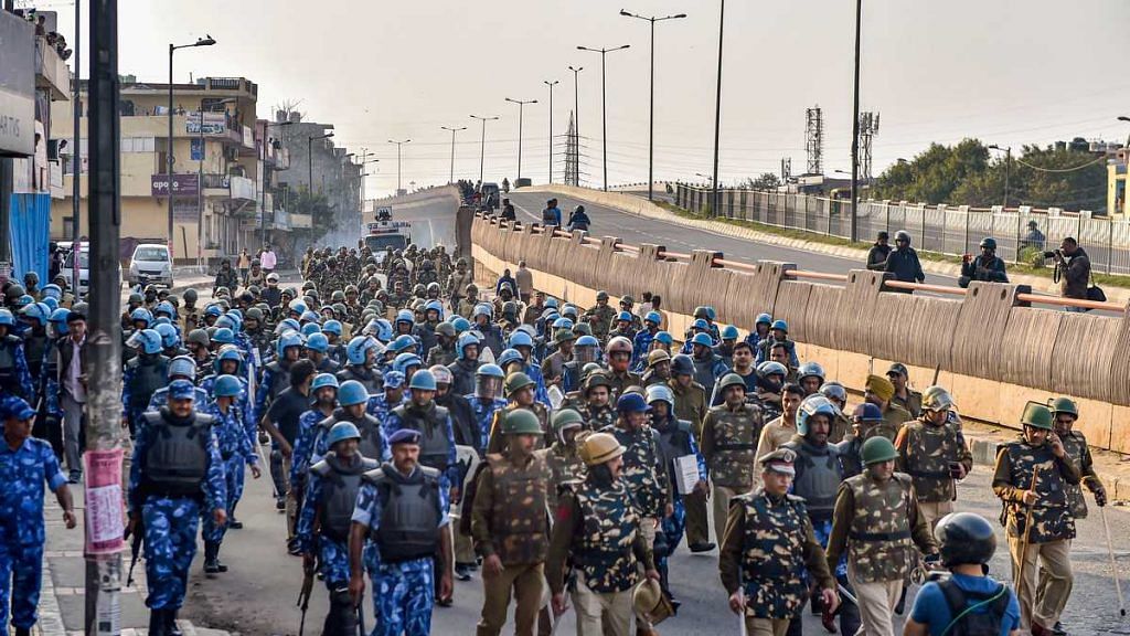 Security personnel conduct a flag march during communal riots in northeast Delhi on 25 February 2020 | Ravi Choudhary | PTI