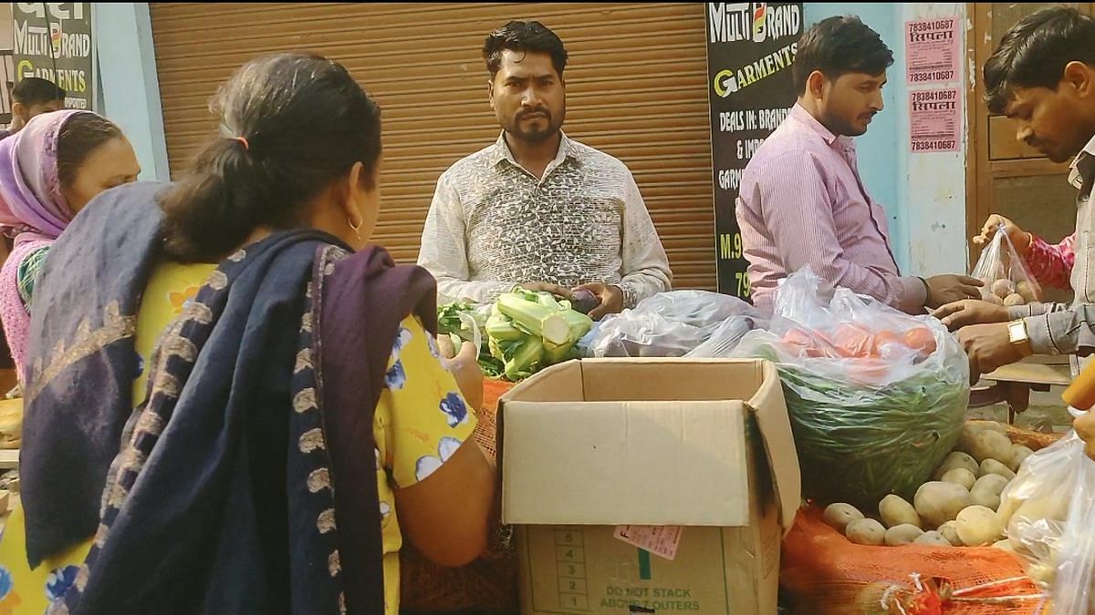 Residents buy vegetables from a street vendor in Mustafabad | Photo: Samyak Pandey | ThePrint