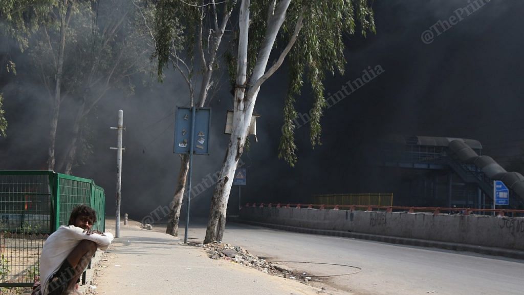 Smoke from the tyre market set on fire in Gokulpuri
