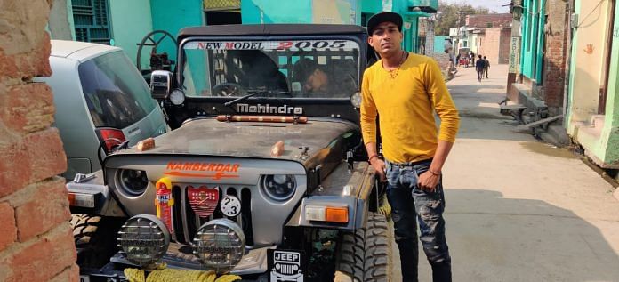 Pushpendar (26) with his newly bought SUV in Rohi Village | Photo: Sajid Ali | ThePrint