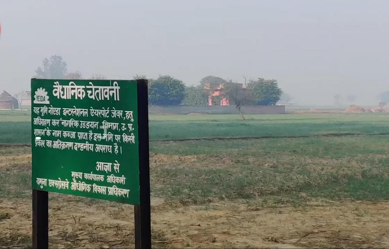 A signpost declaring the land acquisition for the Noida International Airport in Jewar | Photo: Unnati Sharma | ThePrint