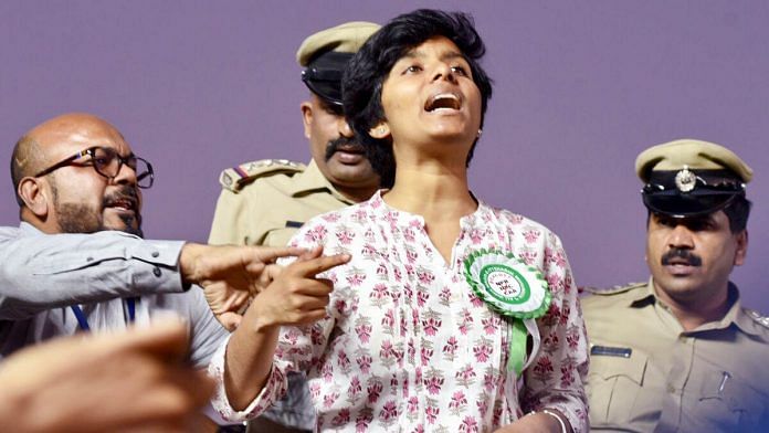 Amulya Noronha being stopped by the organisers and police after she raised slogans during a protest rally against CAA by AIMIM chief Asaduddin Owaisi in Bengaluru Thursday. | Photo: ANI