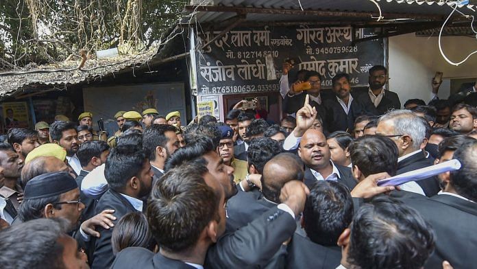 Sanjeev Lodhi (R with raised finger), joint secretary of the Lucknow bar association, along with other lawyers stage a protest after a crude-bomb exploded in the premises of a court, in Lucknow, Thursday. | PTI