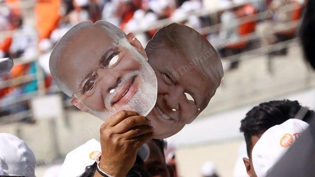 A man holding masks of Prime Minister Narendra Modi and US President Donald Trump at the Motera stadium in Ahmedabad. Photo: Praveen Jain/ThePrint