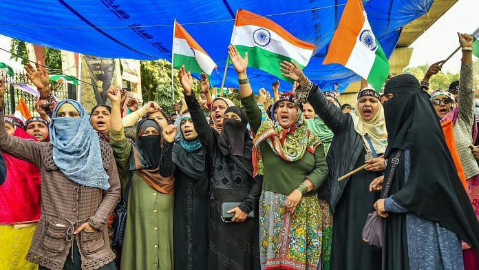 Protestors holding Tricolour flags raise slogans during a protest against CAB, NCR, NPR at Jamia college, in New Delhi | PTI