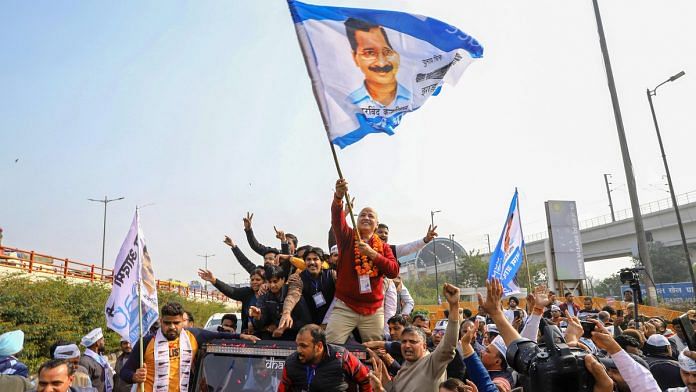 Delhi Dy CM and AAP leader Manish Sisodia waves a flag as he celebrates along with his supporters after winning from the Patparganj Assembly seat, in New Delhi, Tuesday, 11 Feb, 2020. | PTI