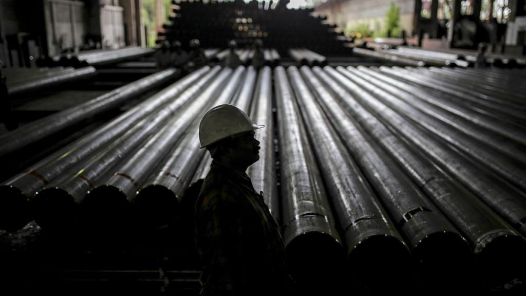 A worker stands in front of steel tubes at the Steel Authority of India Ltd in Rourkela, Odisha | Dhiraj Singh | Bloomberg File photo