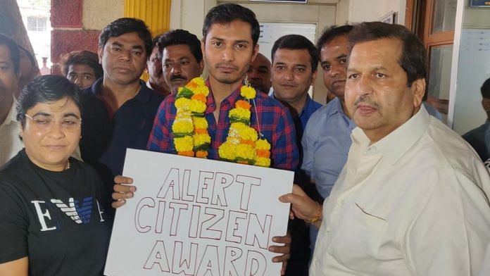 Mumbai BJP chief Mangal Prabhat Lodha awards Uber cab driver Rohit Gaur | Twitter @MPLodha