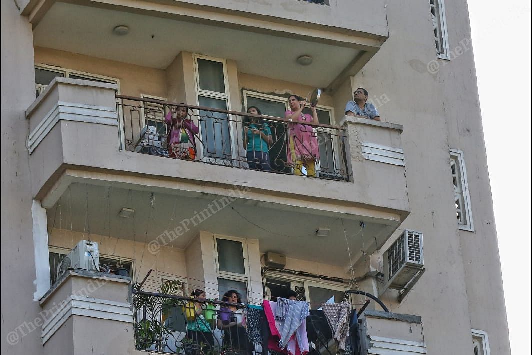 People clap standing at their balconies | Photo: Suraj Singh Bisht | ThePrint