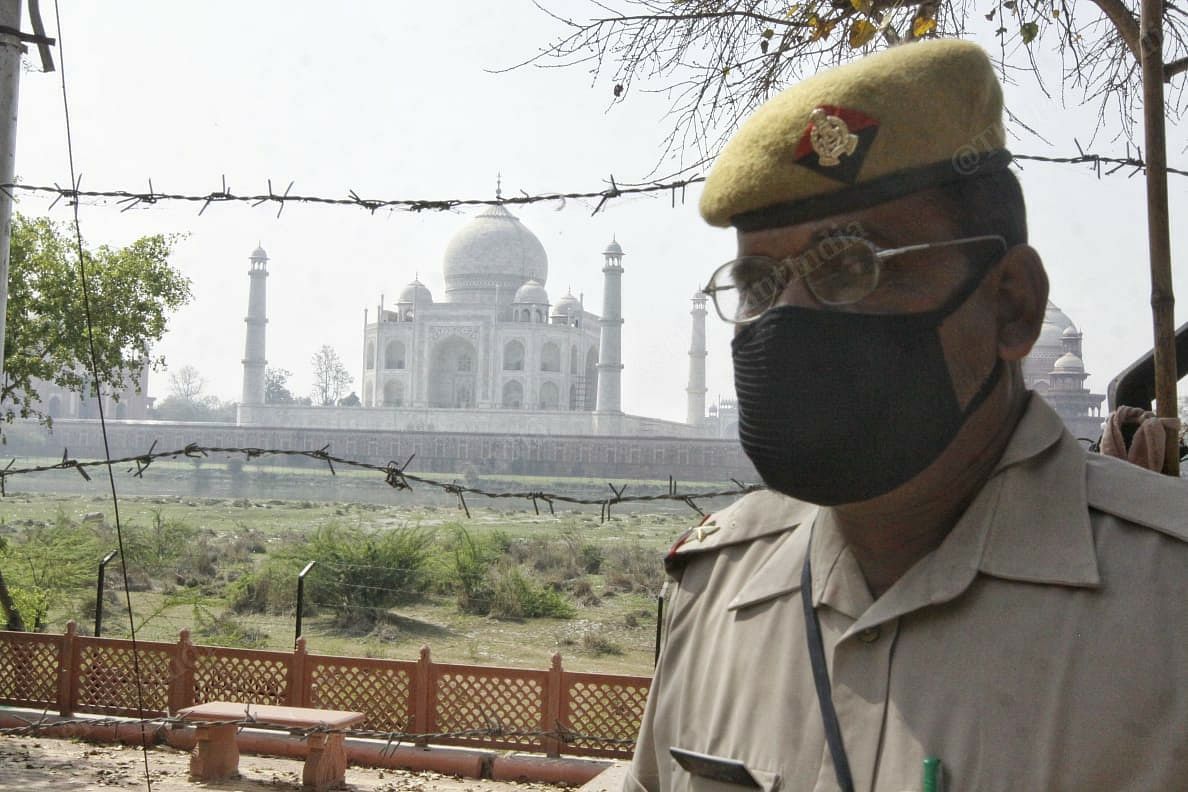 A police officer wearing mask stand outside Taj Mahal premises in Agra | Photo: Praveen Jain | ThePrint