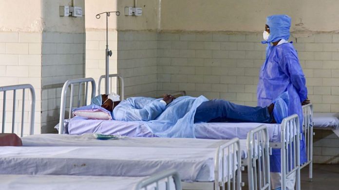 A medic looks on at a patient who has shown positive symptoms for coronavirus at an isolation ward in Hyderabad on 10 March