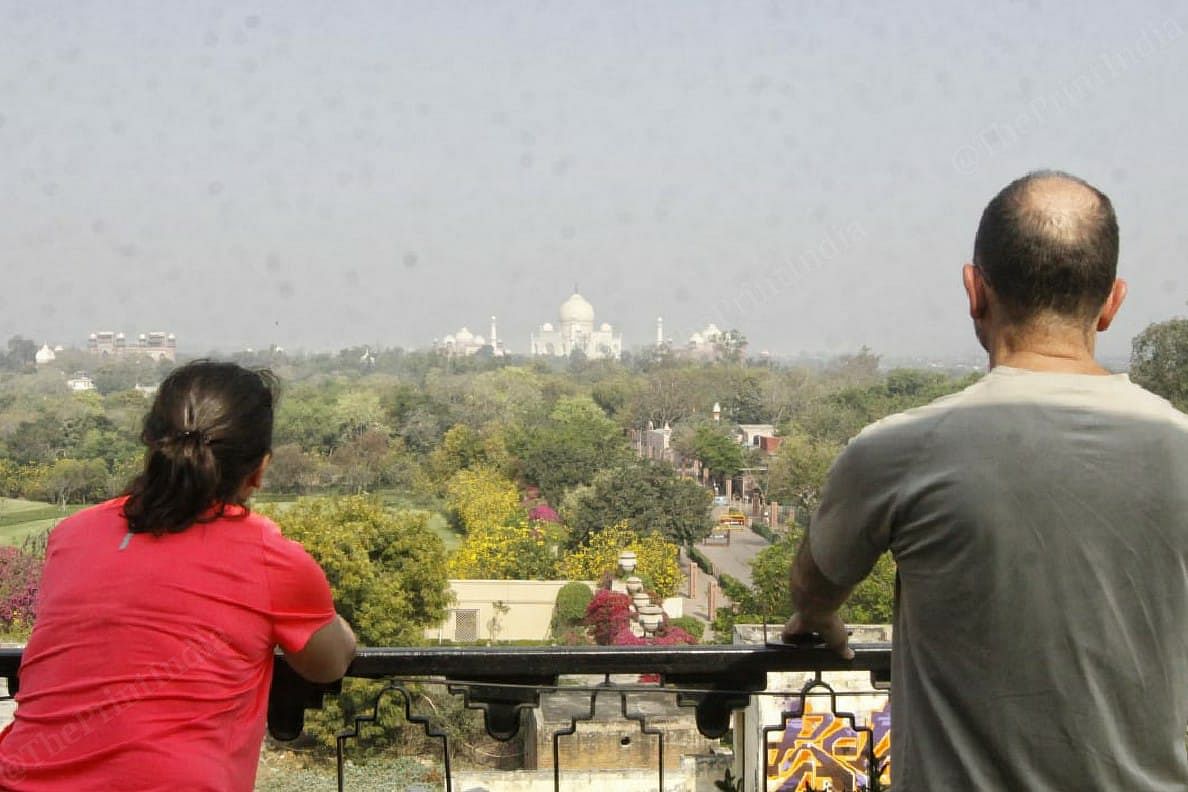 Francisco and his wife Belen from Spain arrived in India on 4th of March and their stuck in Agra. On the Janata curfew day they look at Taj Mahal from their hotel | Photo: Praveen Jain | ThePrint