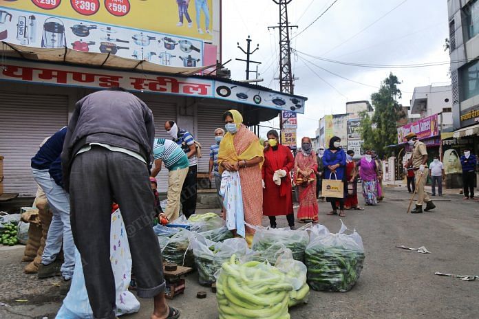 People queue up to buy vegetables | Photo: Manisha Mondal | ThePrint