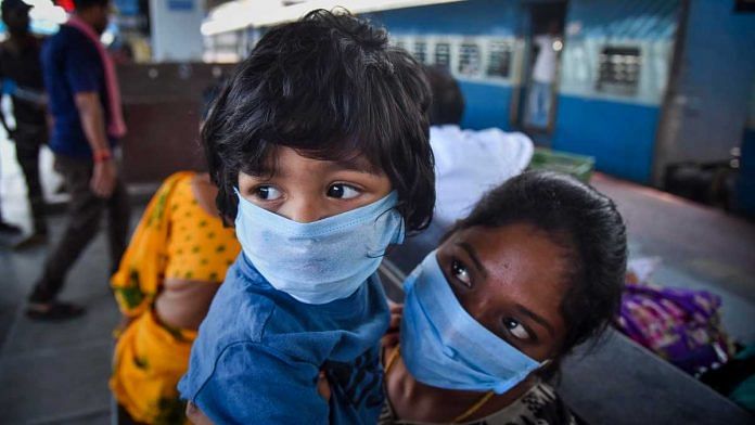 Passengers wear protective face masks in the wake of novel coronavirus pandemic at a railway station in Vijayawada, on 18 March 2020 | PTI