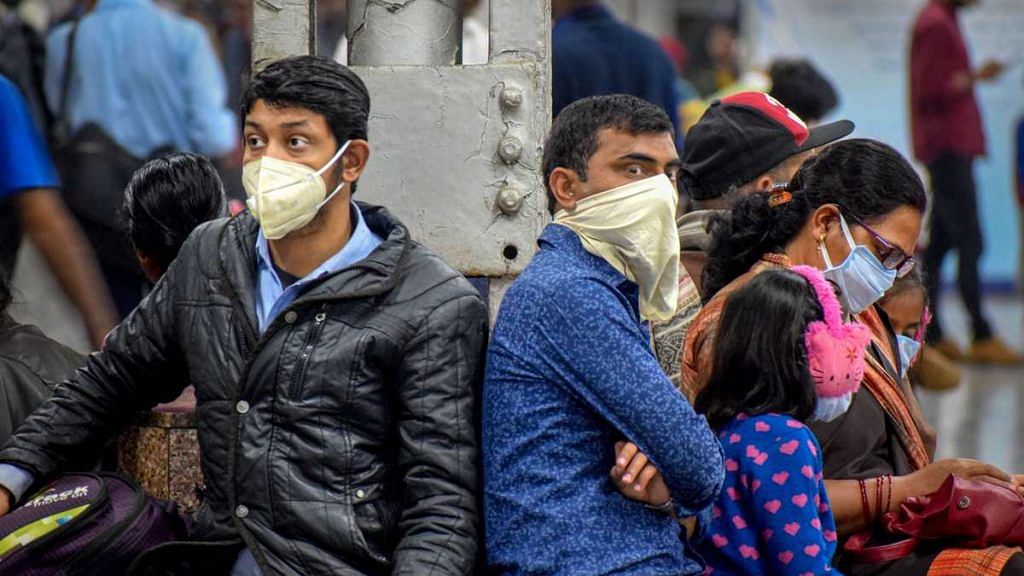 Passengers at the Prayagraj Railway Station wear masks as a preventive measure for coronavirus, on 16 March 2020 | PTI