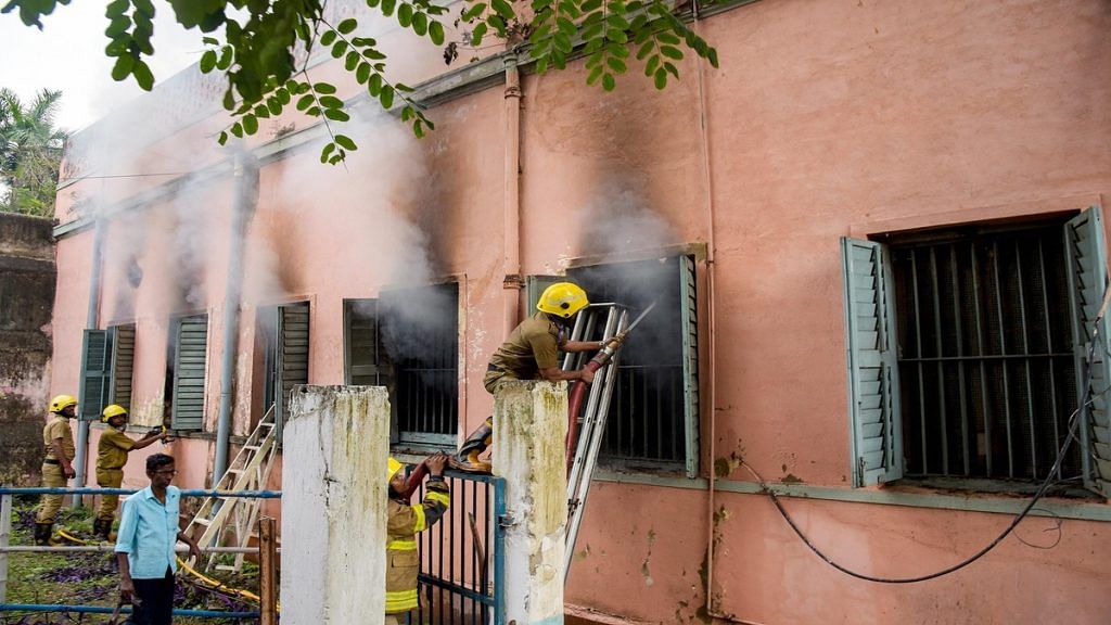 Firefighters try to douse the fire at Dum Dum correctional facility on 21 March, the first day of a clash between inmates and police personnel