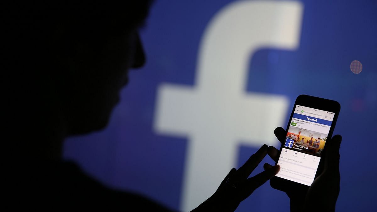 A woman checks the Facebook Inc. site on her smartphone | Chris Ratcliffe | Bloomberg
